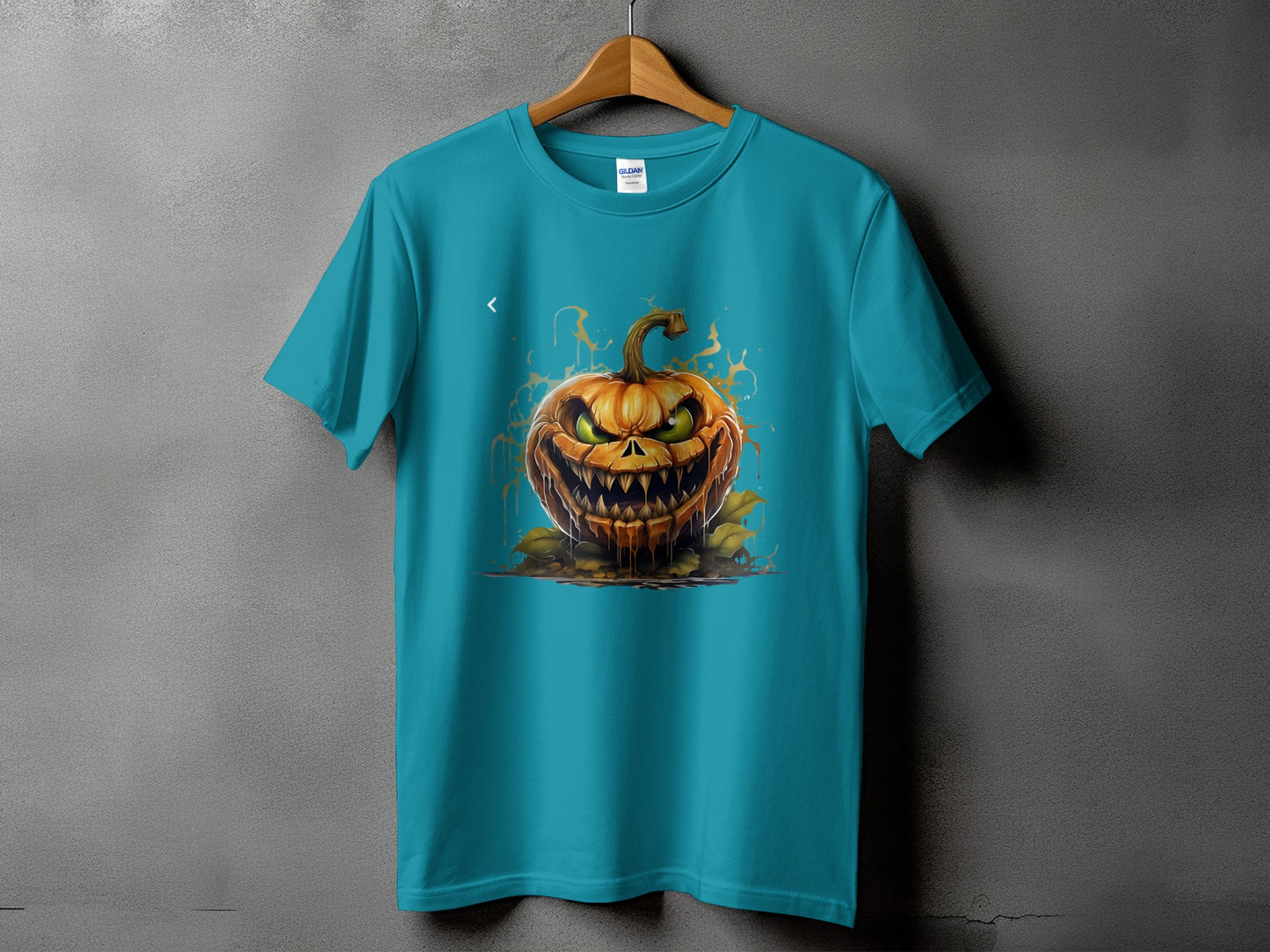 Teal t-shirt with a menacing carved Halloween pumpkin graphic and orange splatters.