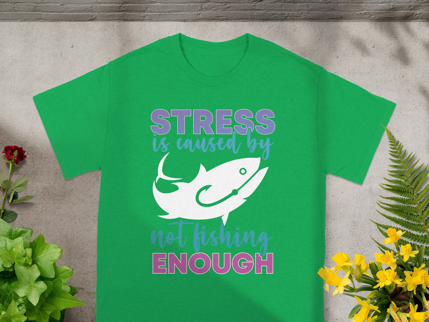 Green t-shirt with "STRESS is caused by" text, a fish graphic, and "not fishing ENOUGH" text.