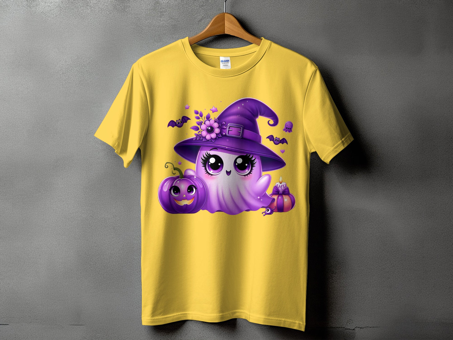 Yellow t-shirt with purple ghost wearing a witch hat, pumpkin, bats, and candle.