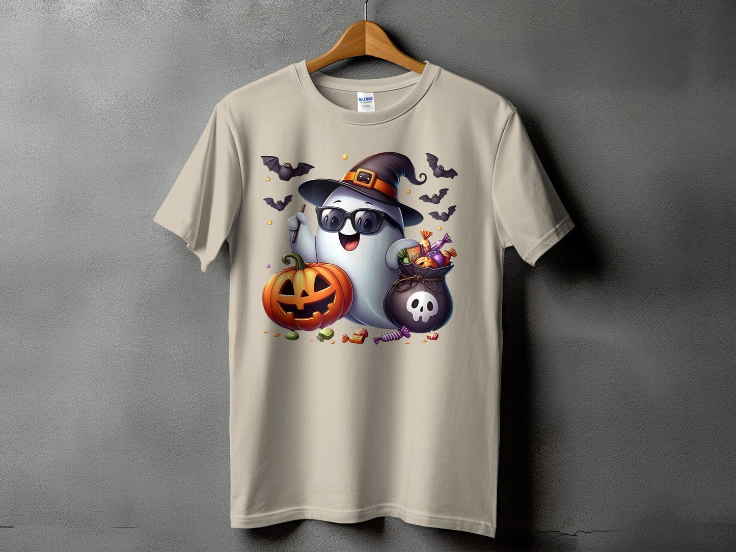 Ghost with witch hat, sunglasses, pumpkin, candy bag, and bats on t-shirt.