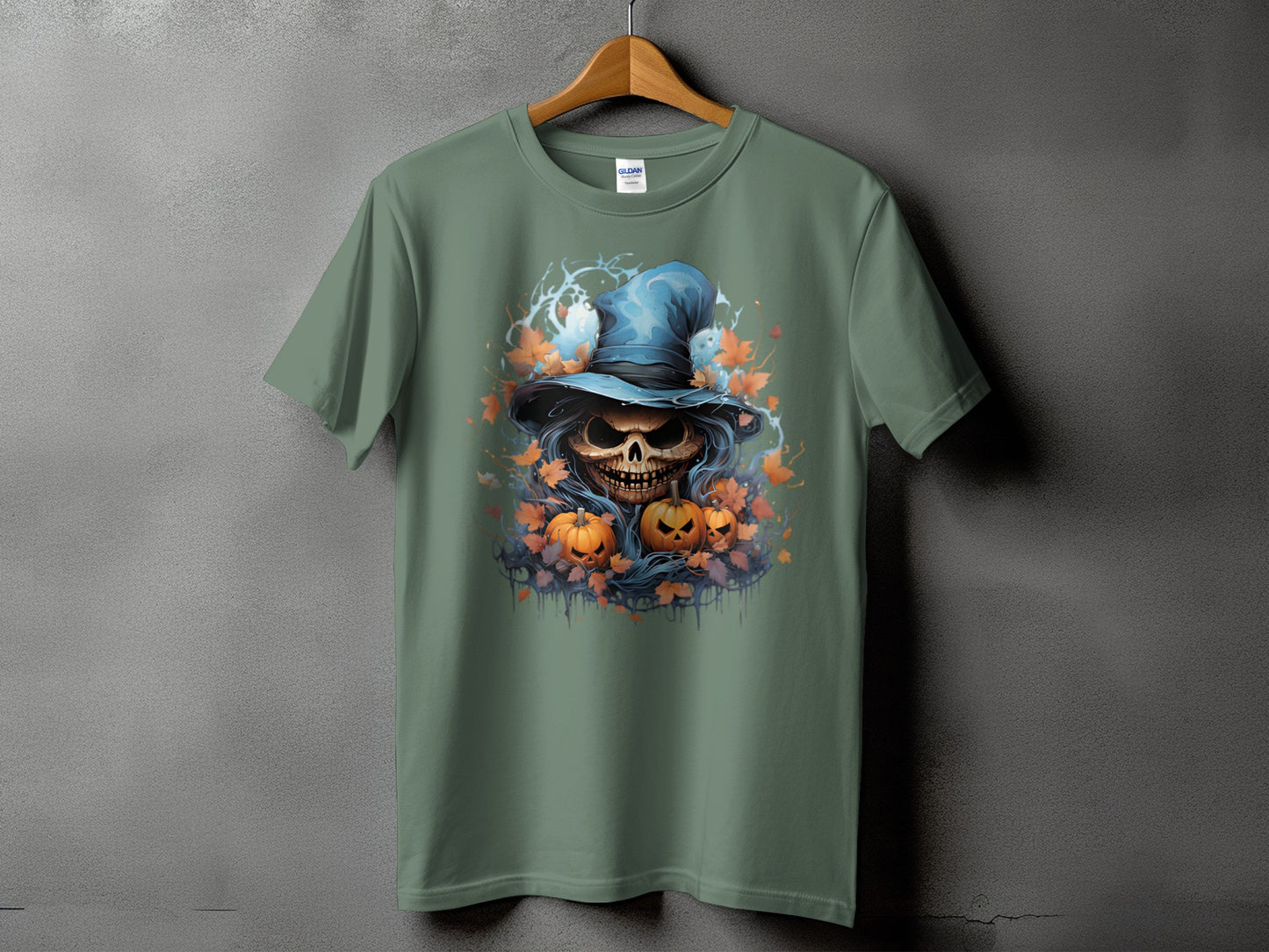Green t-shirt with a Halloween graphic of a skull in a witch hat and pumpkins.