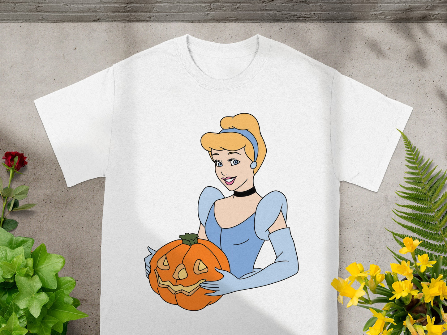 Cinderella holds a Jack-o'-lantern on a white t-shirt.