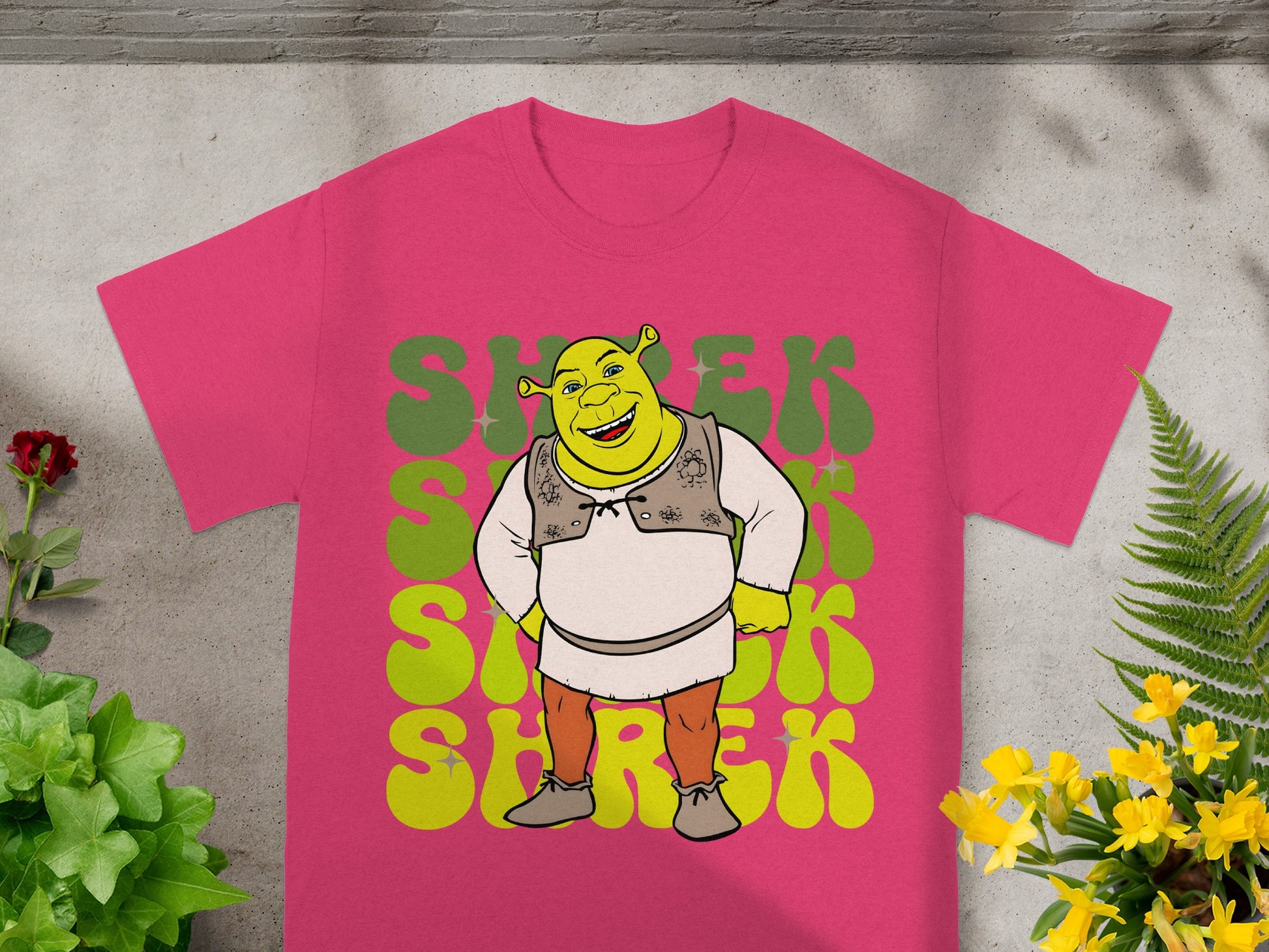 Pink t-shirt featuring Shrek character and repeated "SHREK" text.