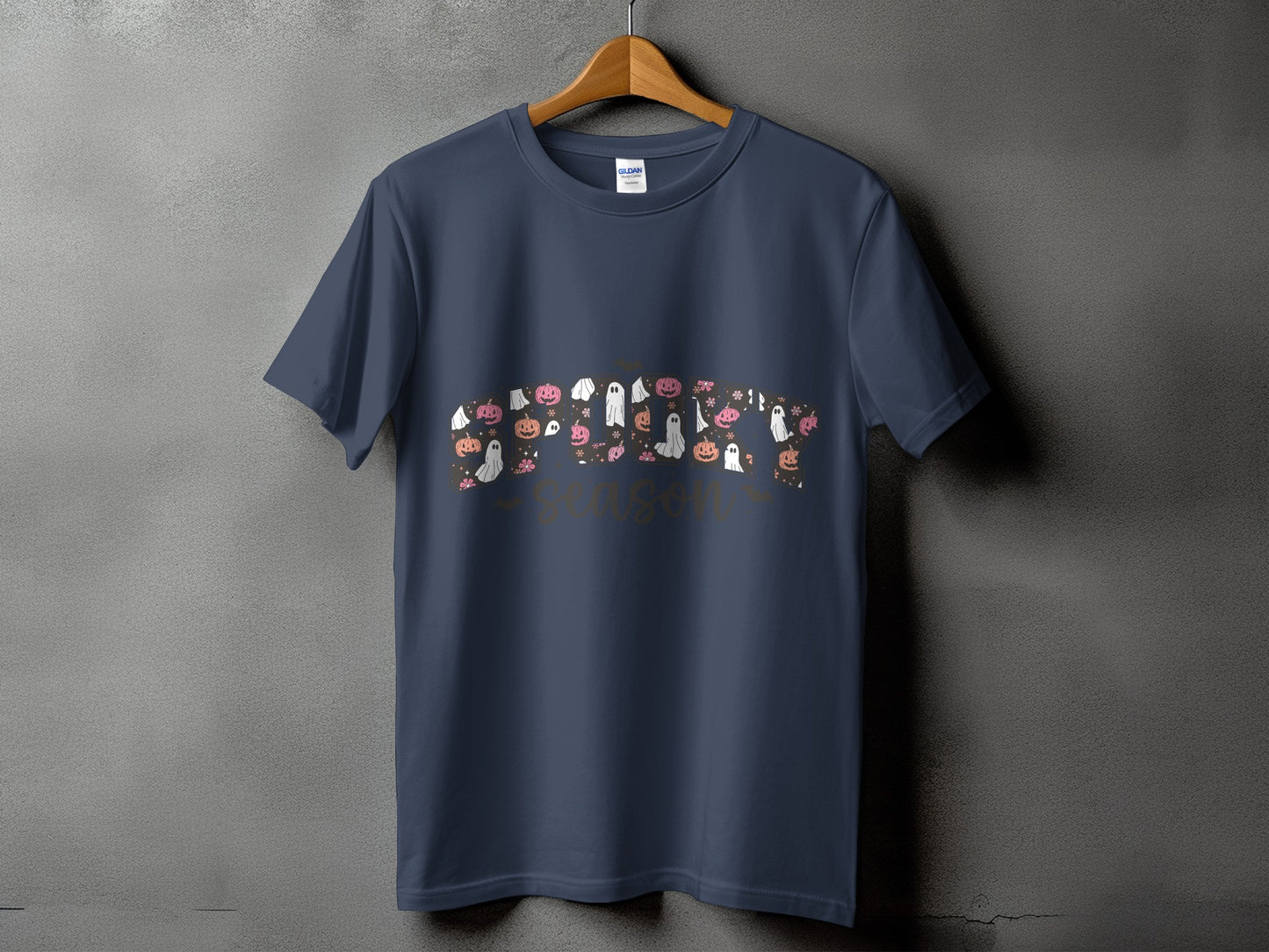 Dark blue t-shirt with Halloween-themed ghosts, pumpkins, and flowers, and text "spooky season."
