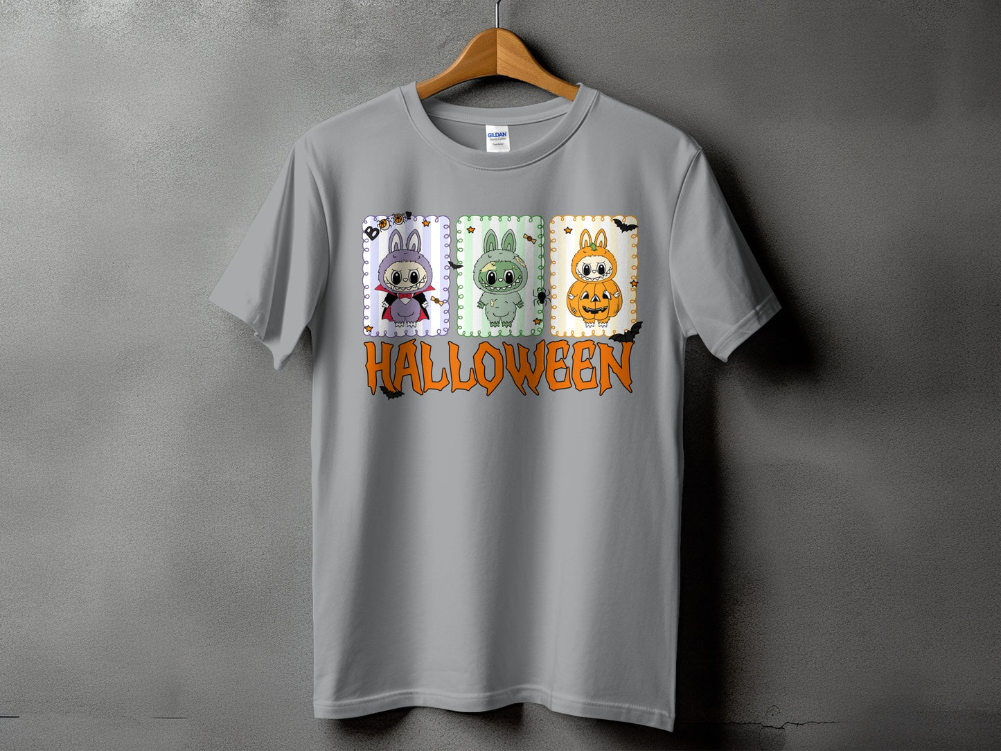 Grey t-shirt with three cartoon bunnies dressed for Halloween and the word HALLOWEEN.
