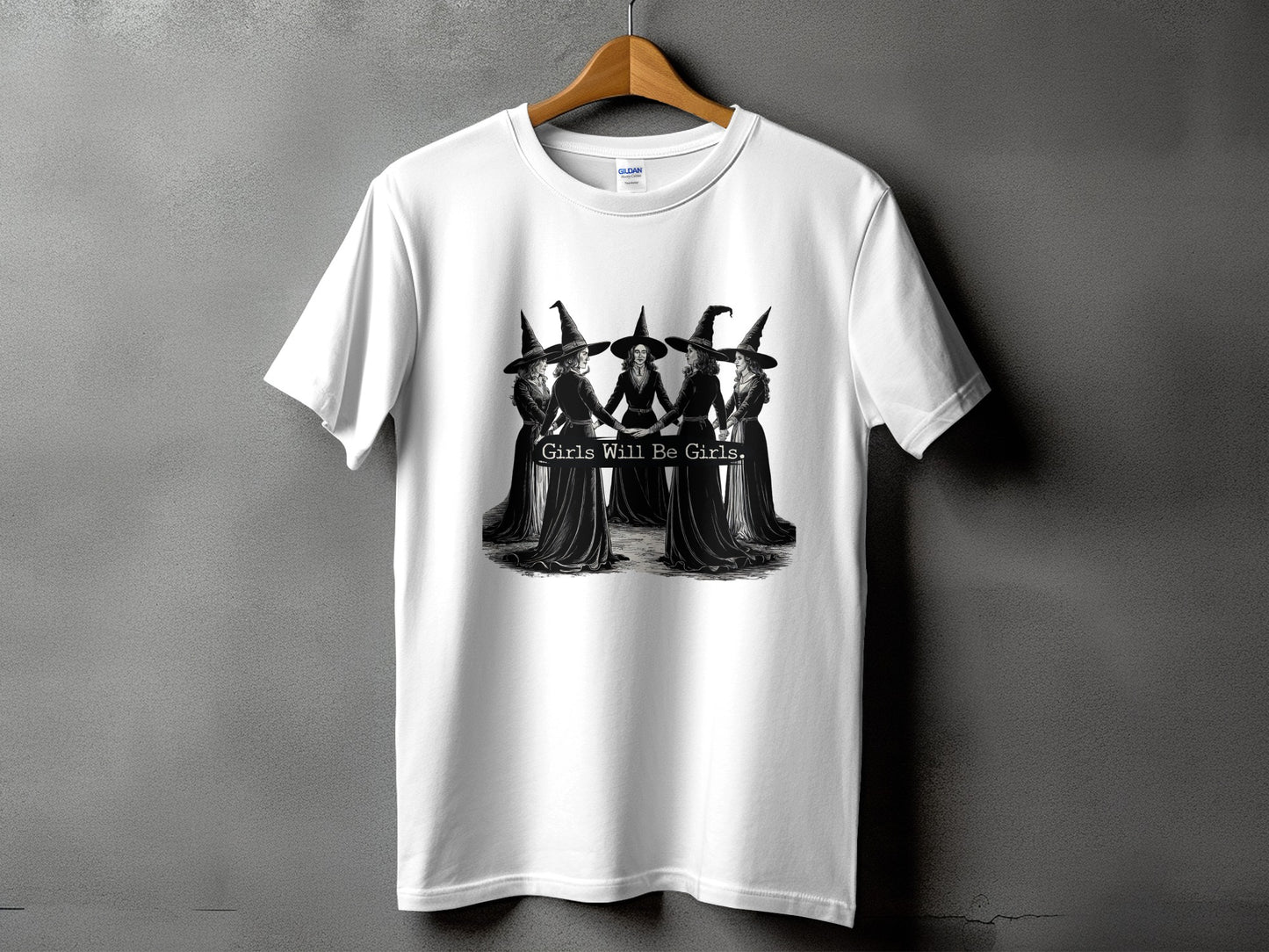White t-shirt with graphic of five witches holding hands, saying "Girls Will Be Girls."