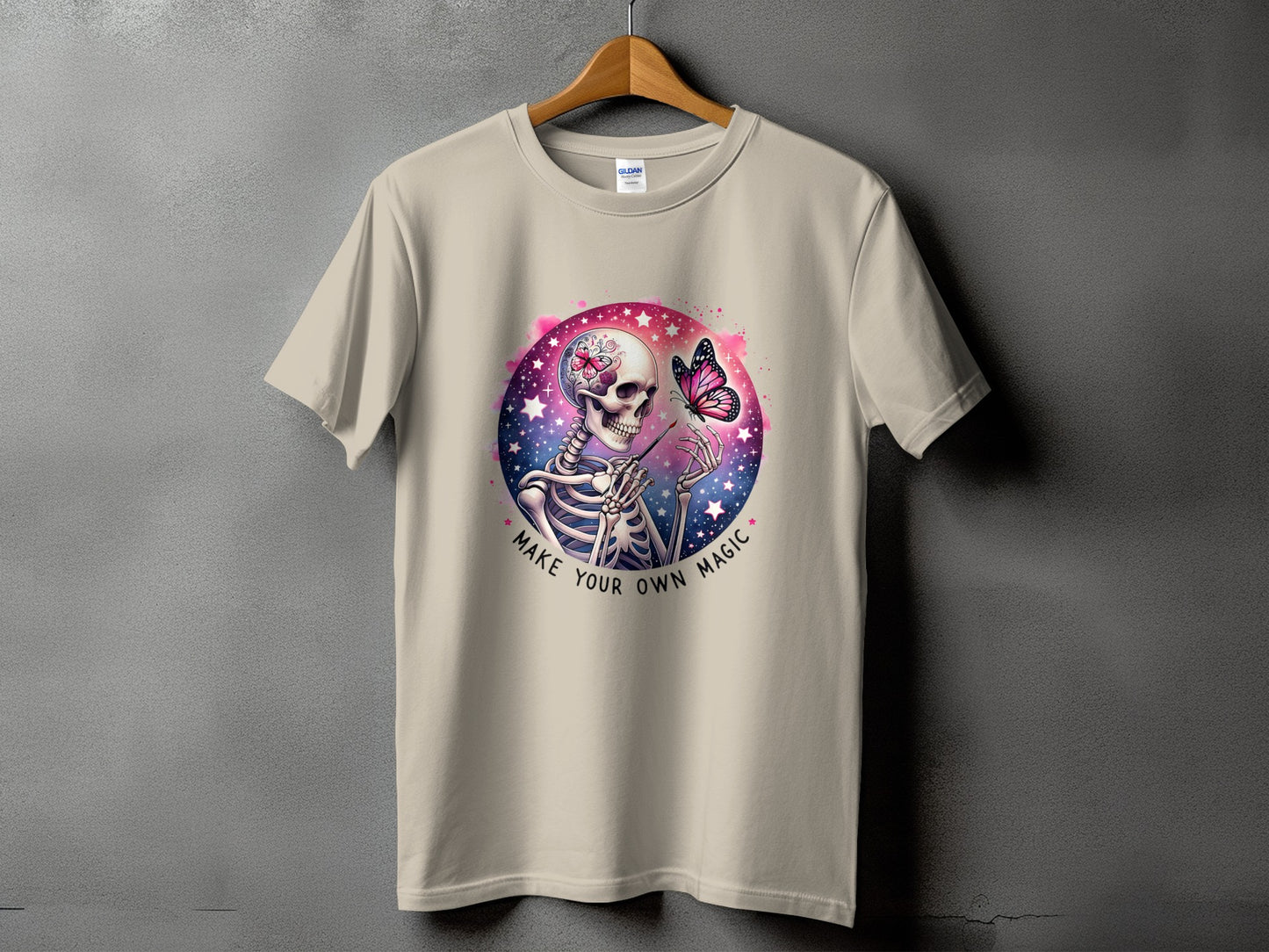 Skeleton with butterfly on shirt, text "MAKE YOUR OWN MAGIC".