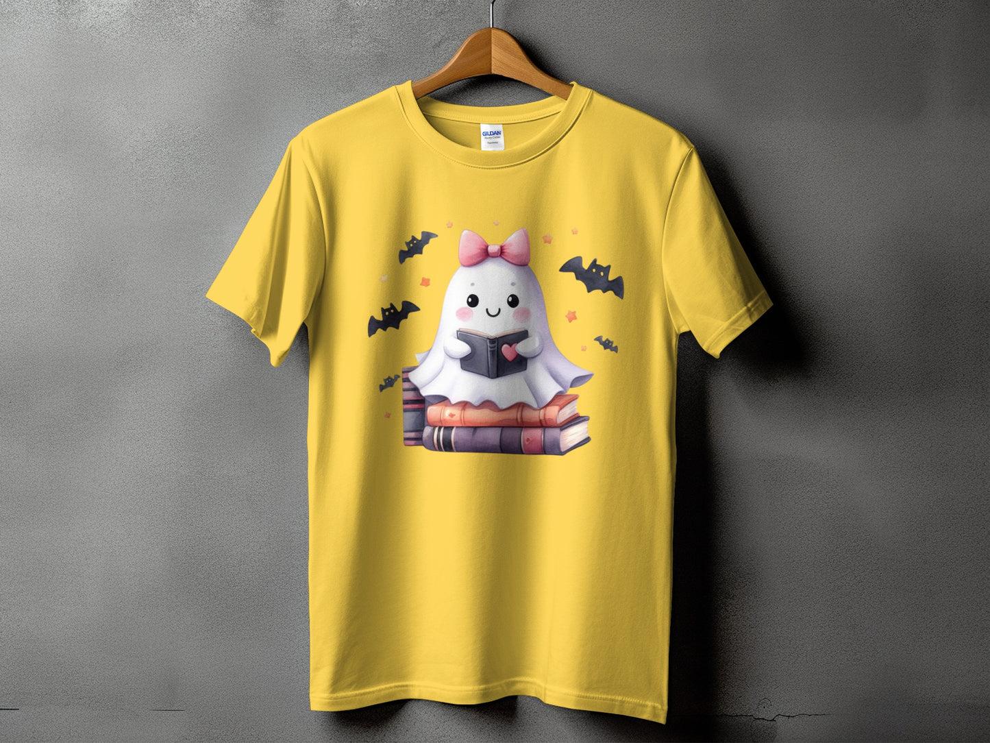 Yellow t-shirt with a cute ghost reading a book, surrounded by bats.