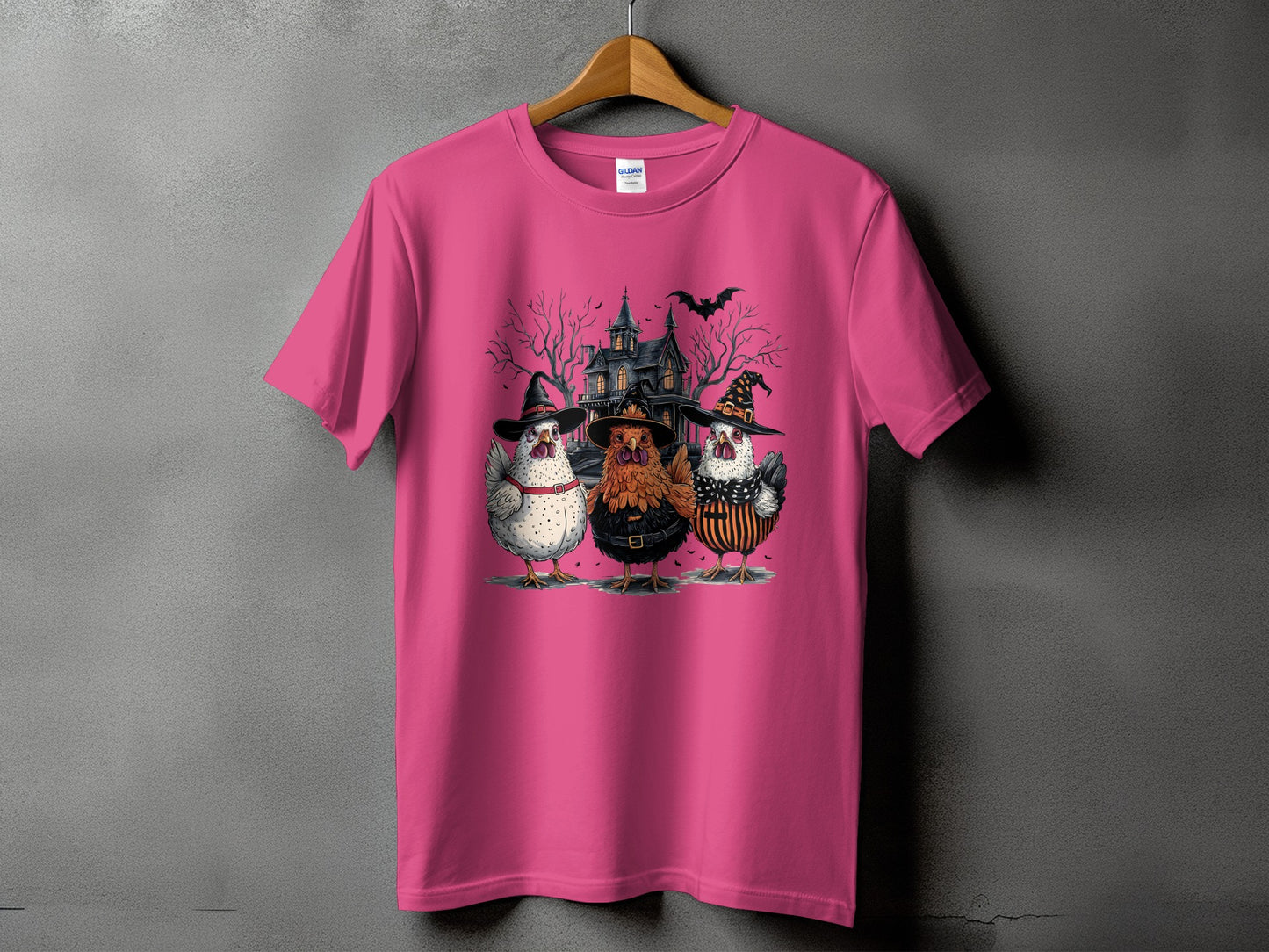 Three chickens in witch hats stand before a haunted house.