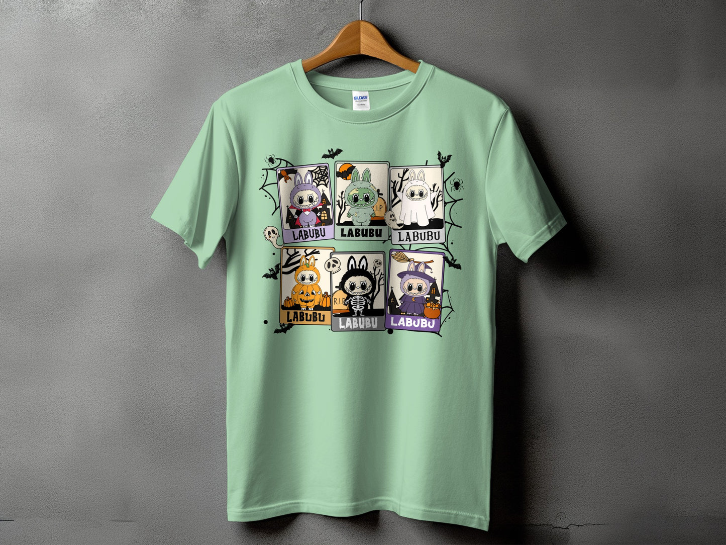 Light green t-shirt with a Halloween-themed grid of Labubu characters.
