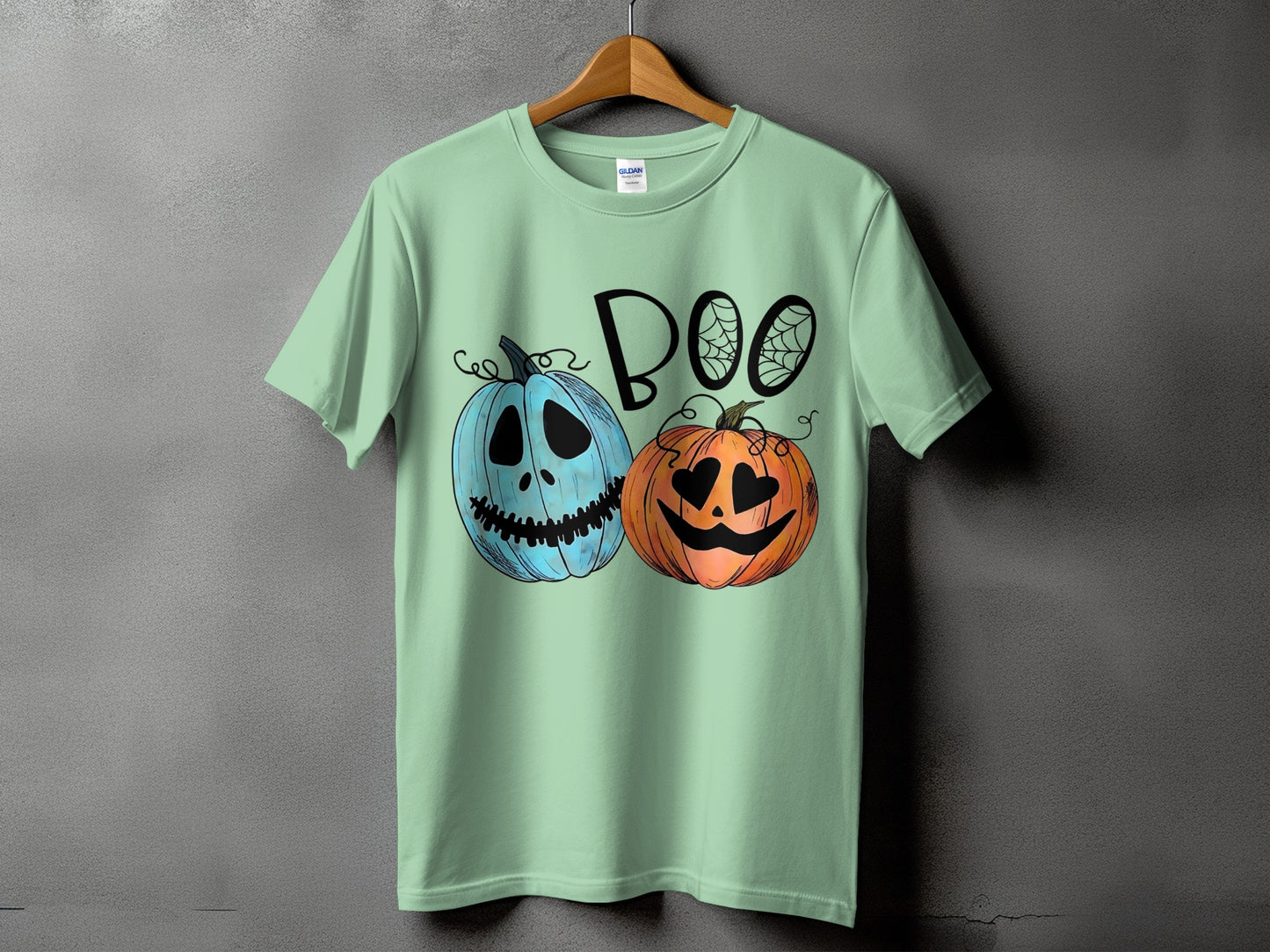 Mint t-shirt with "BOO" text and two cartoon pumpkins.