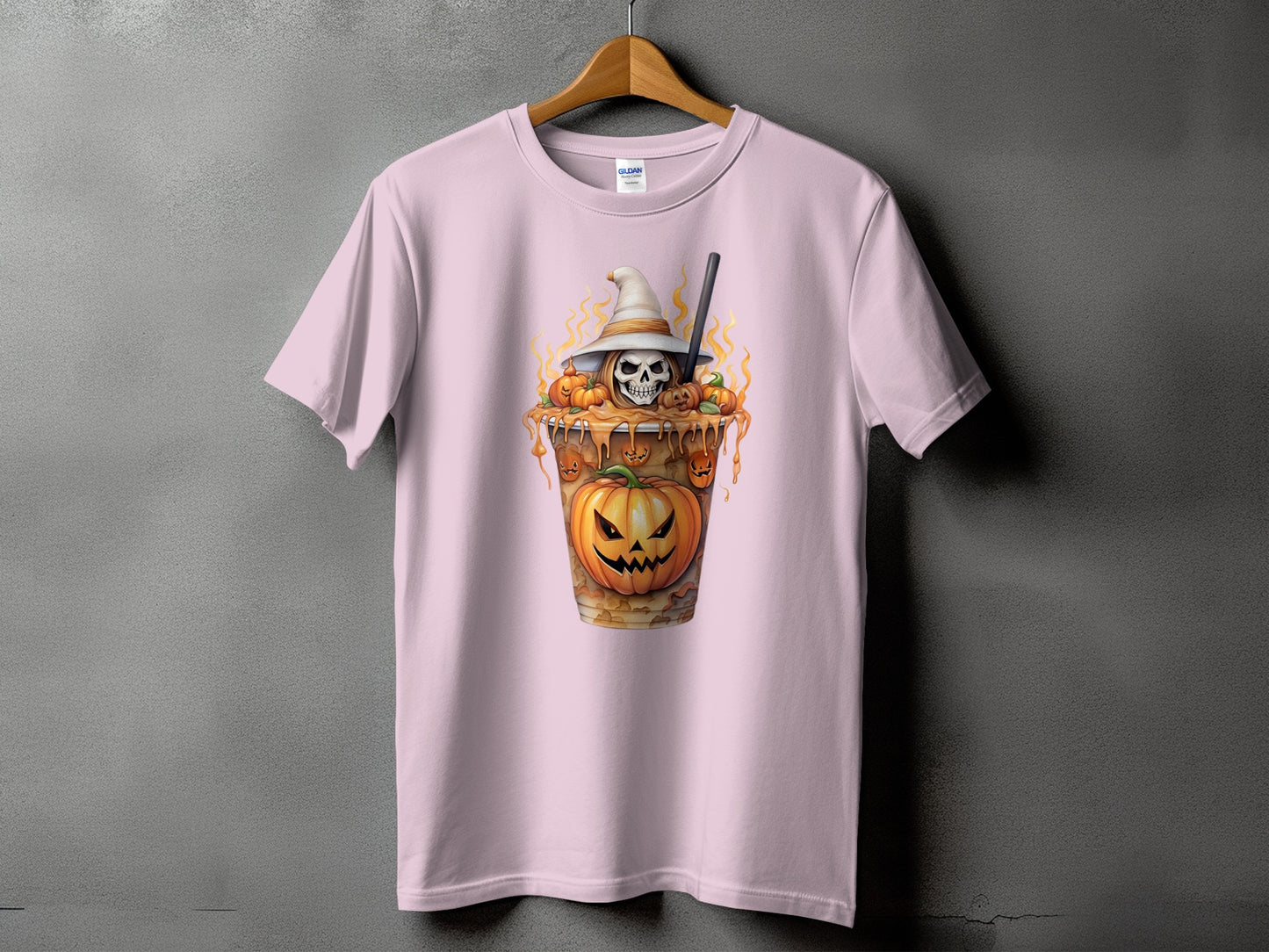Pink t-shirt with a Halloween-themed graphic of a skull and pumpkins in a cup.
