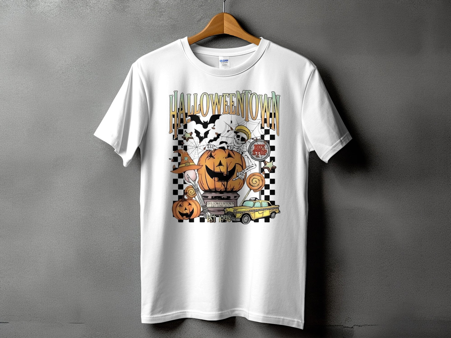 White t-shirt with Halloween Town graphic featuring a pumpkin, skeleton, and yellow taxi.