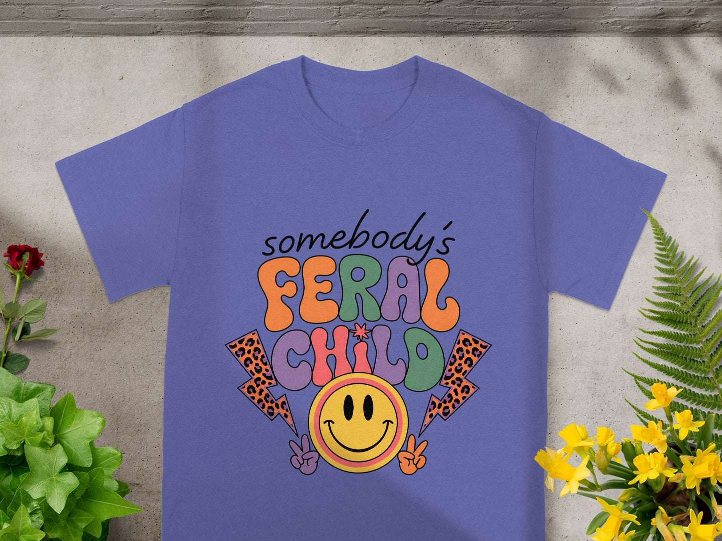 Purple t-shirt with "somebody's FERAL CHILD" text and a smiley face.