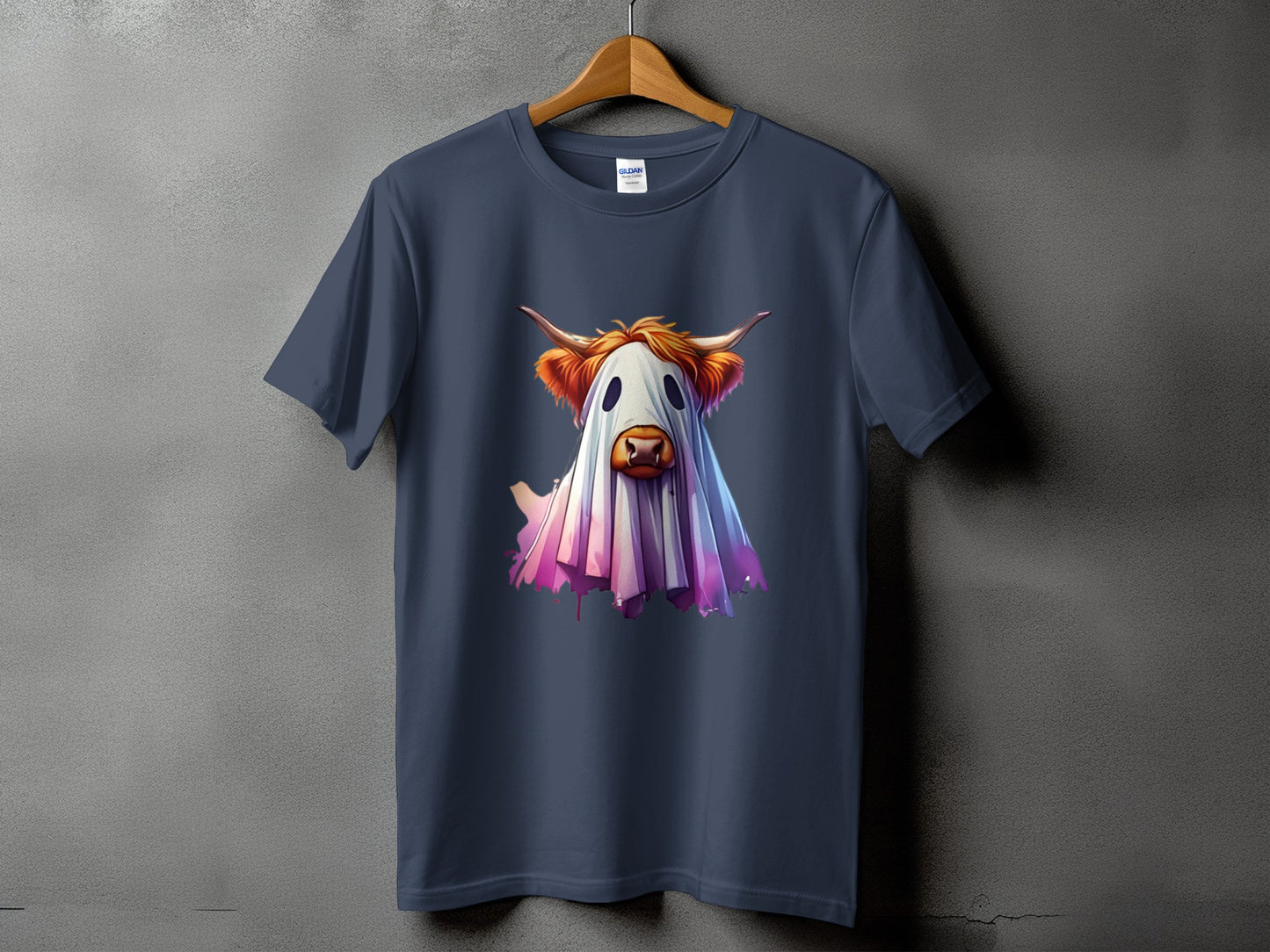Dark grey t-shirt with a graphic of a Highland cow wearing a ghost costume.