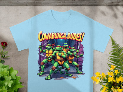 Teenage Mutant Ninja Turtles with swords and "Cowabunga, Dudes!" text on a light blue shirt.