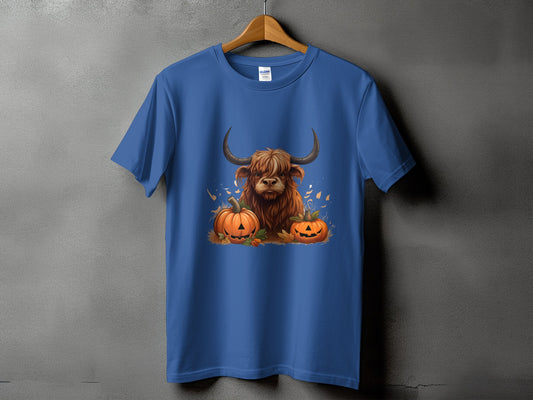 Highland cow with pumpkins graphic on a blue t-shirt.