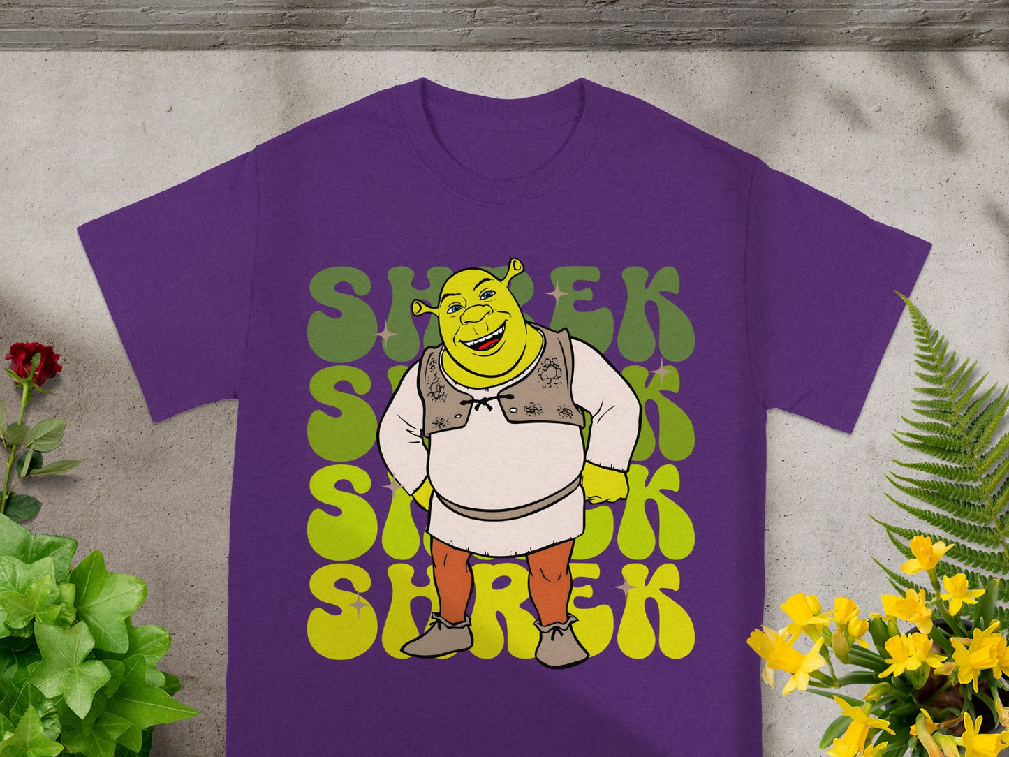 Purple t-shirt with Shrek graphic in green and yellow lettering.