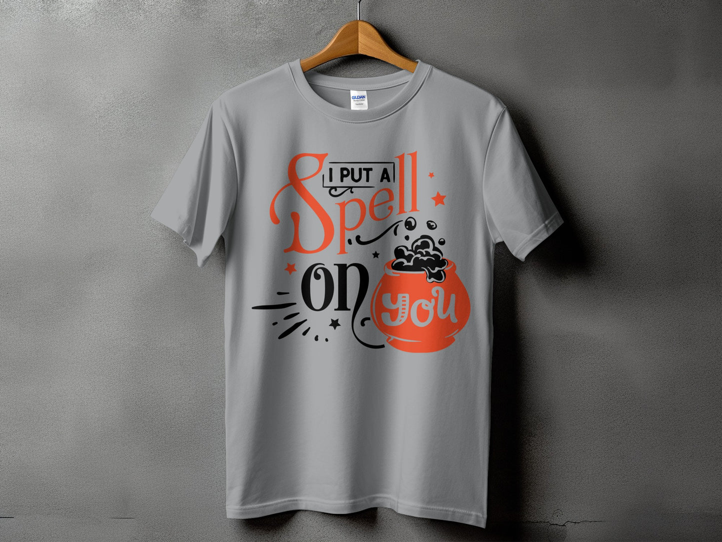 Grey t-shirt with "I put a spell on you" text and cauldron graphic.