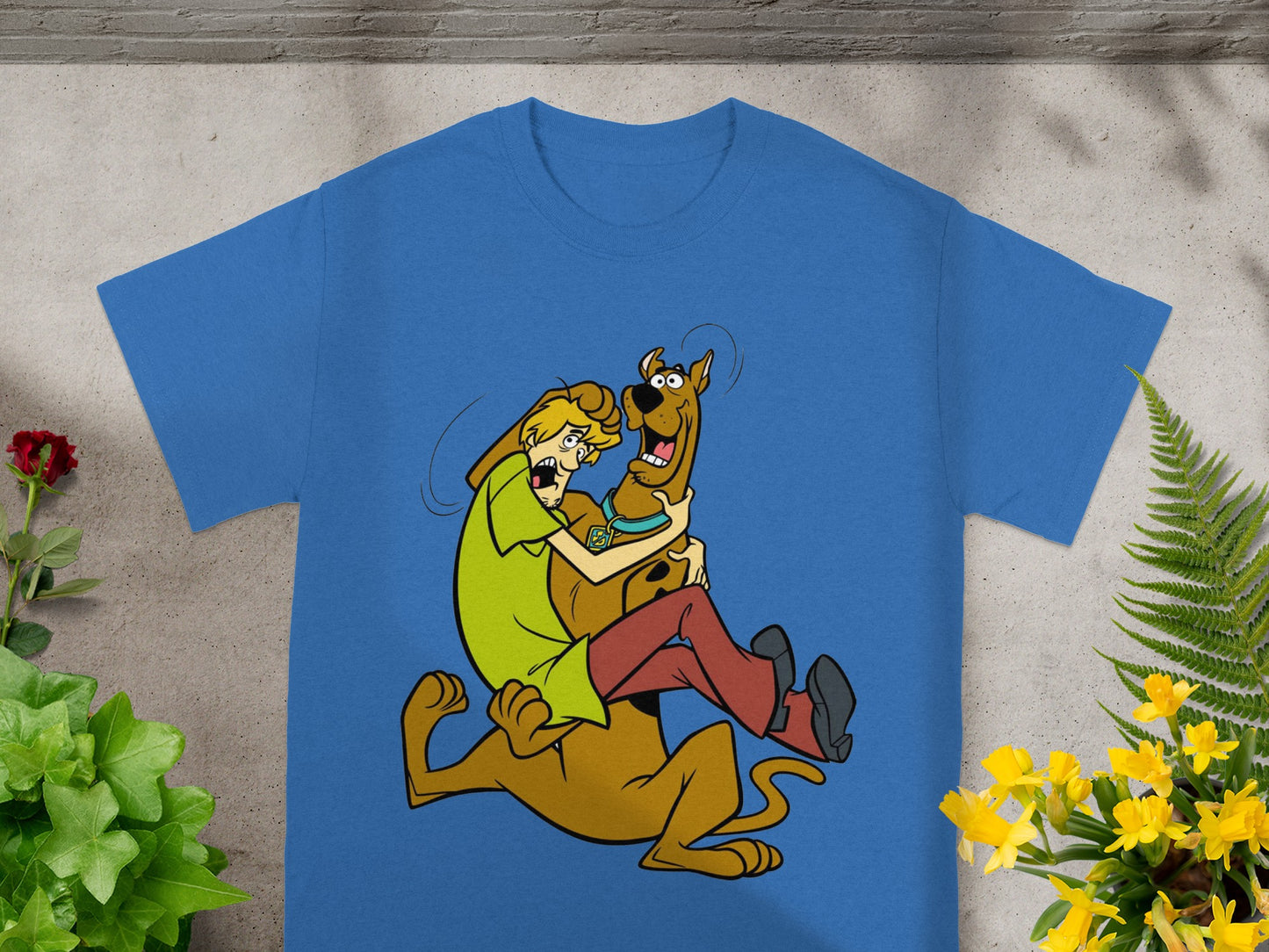 Scooby-Doo and Shaggy embrace on a blue t-shirt.