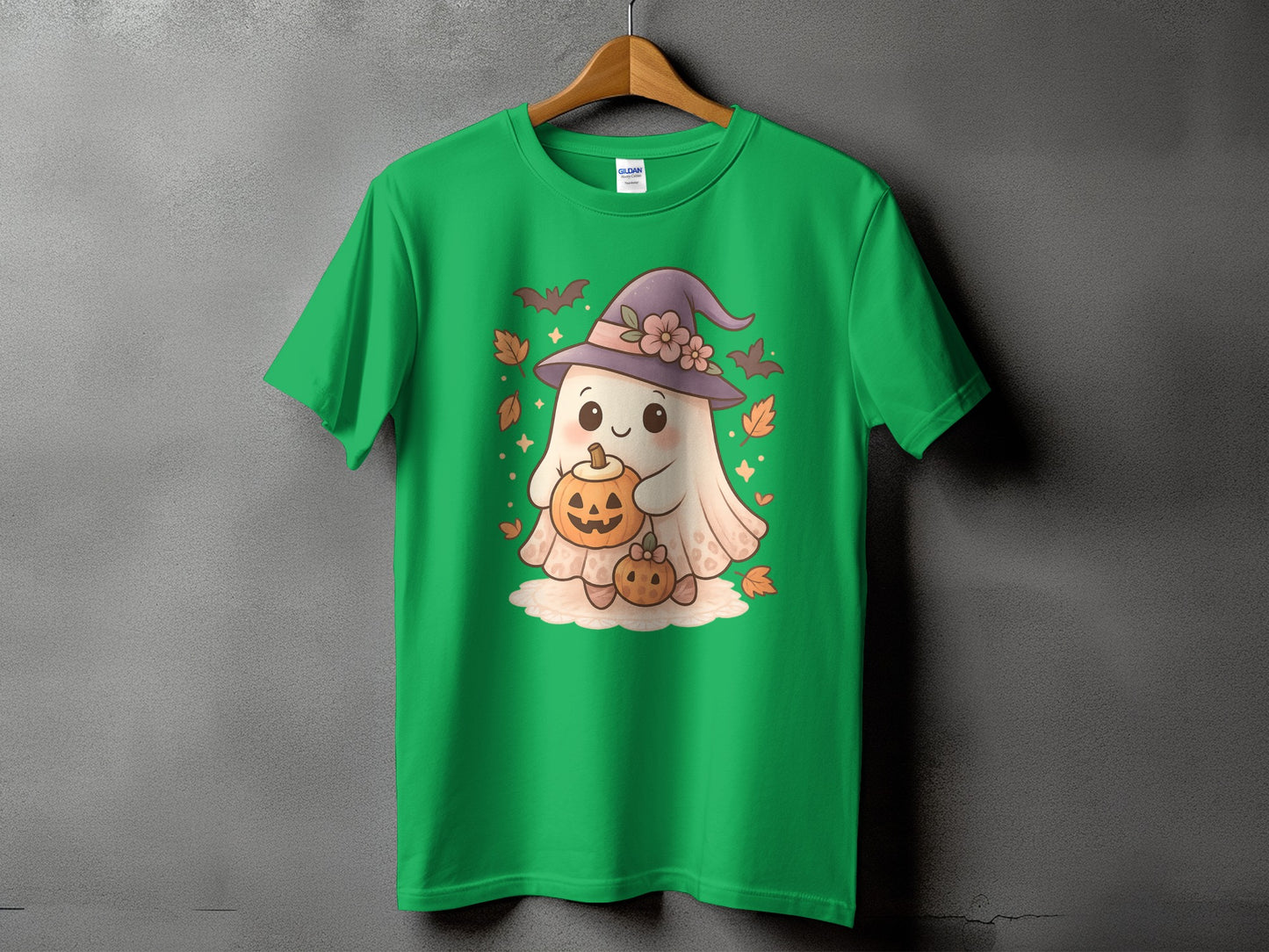 Green t-shirt with a cute ghost wearing a witch hat, holding pumpkins.