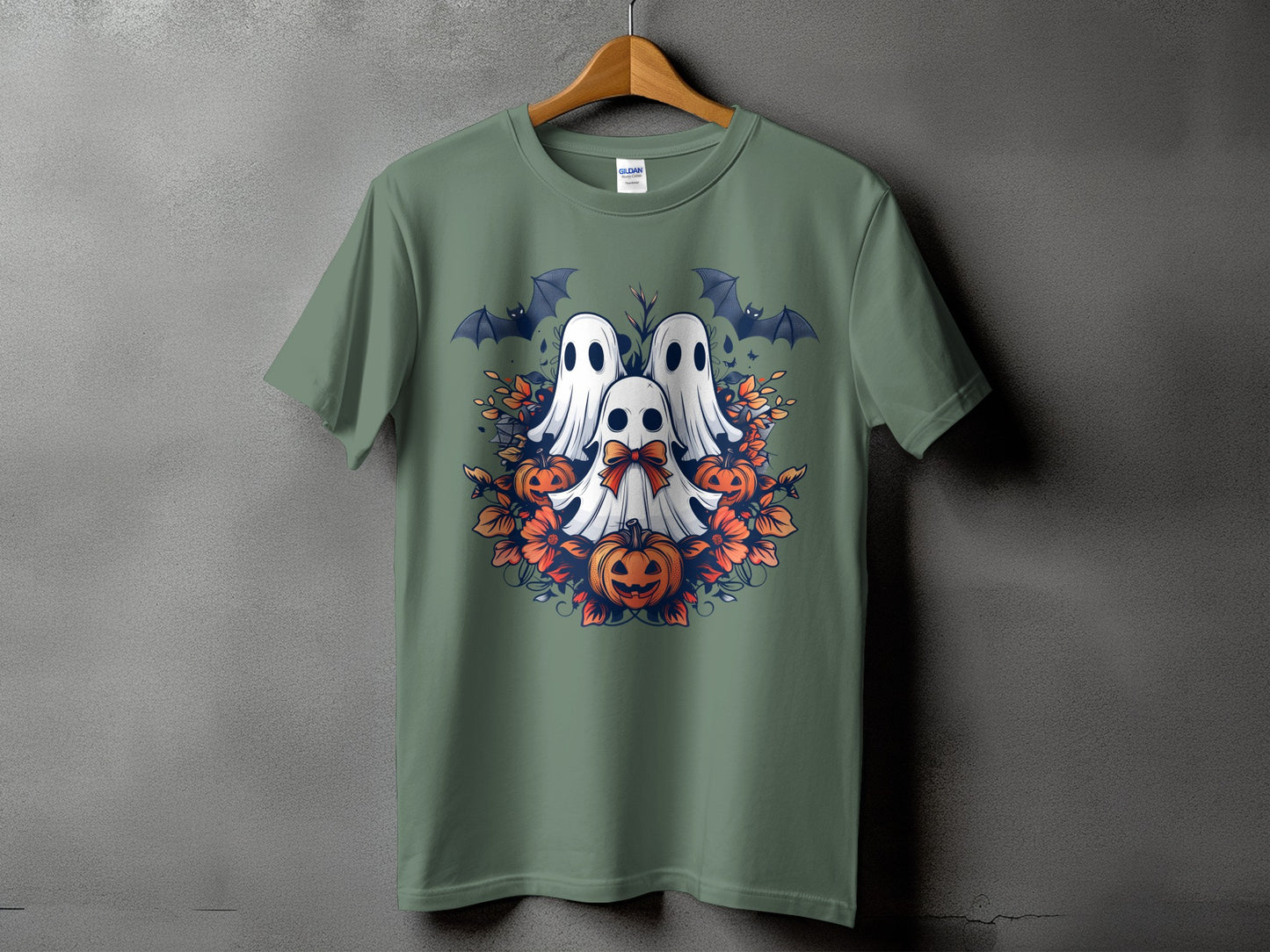 Green t-shirt with a Halloween design featuring ghosts, pumpkins, bats, and floral accents.
