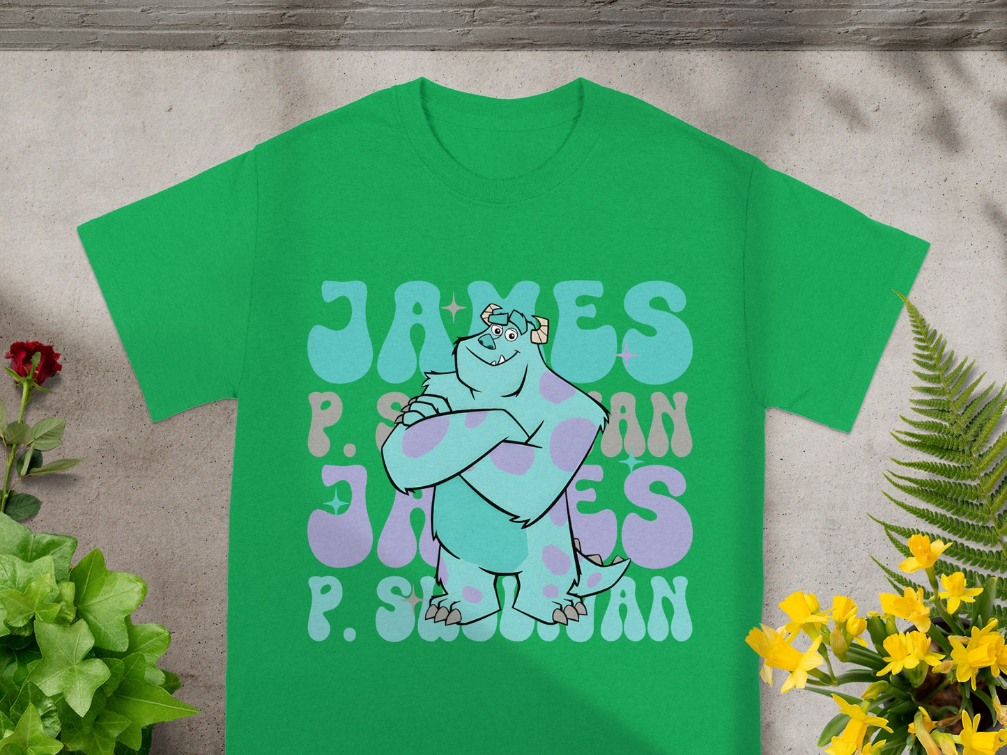 Green t-shirt with "James P. Sullivan" in stylized blue and purple lettering.