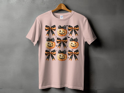 Pink t-shirt with a pattern of jack-o'-lanterns and black and orange bows.