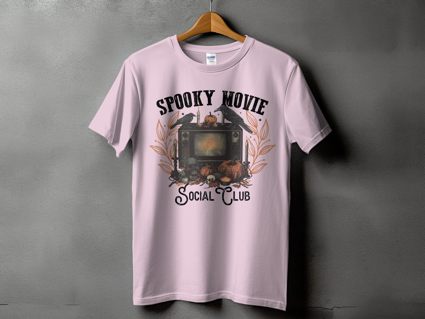 Pink t-shirt with "Spooky Movie Social Club" Halloween graphic.