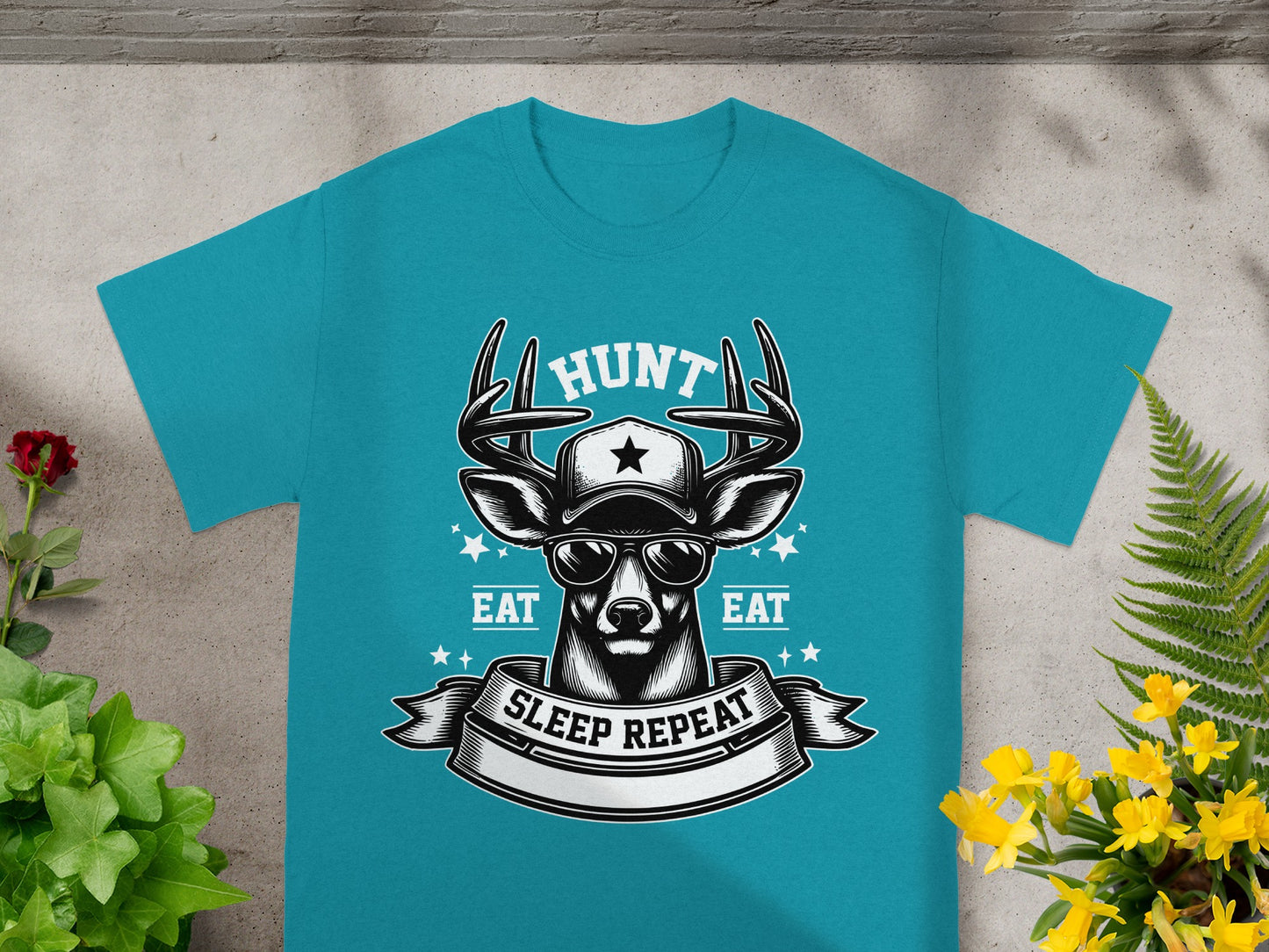 Teal t-shirt with a deer wearing a hat and sunglasses, featuring "HUNT," "EAT," and "SLEEP REPEAT."