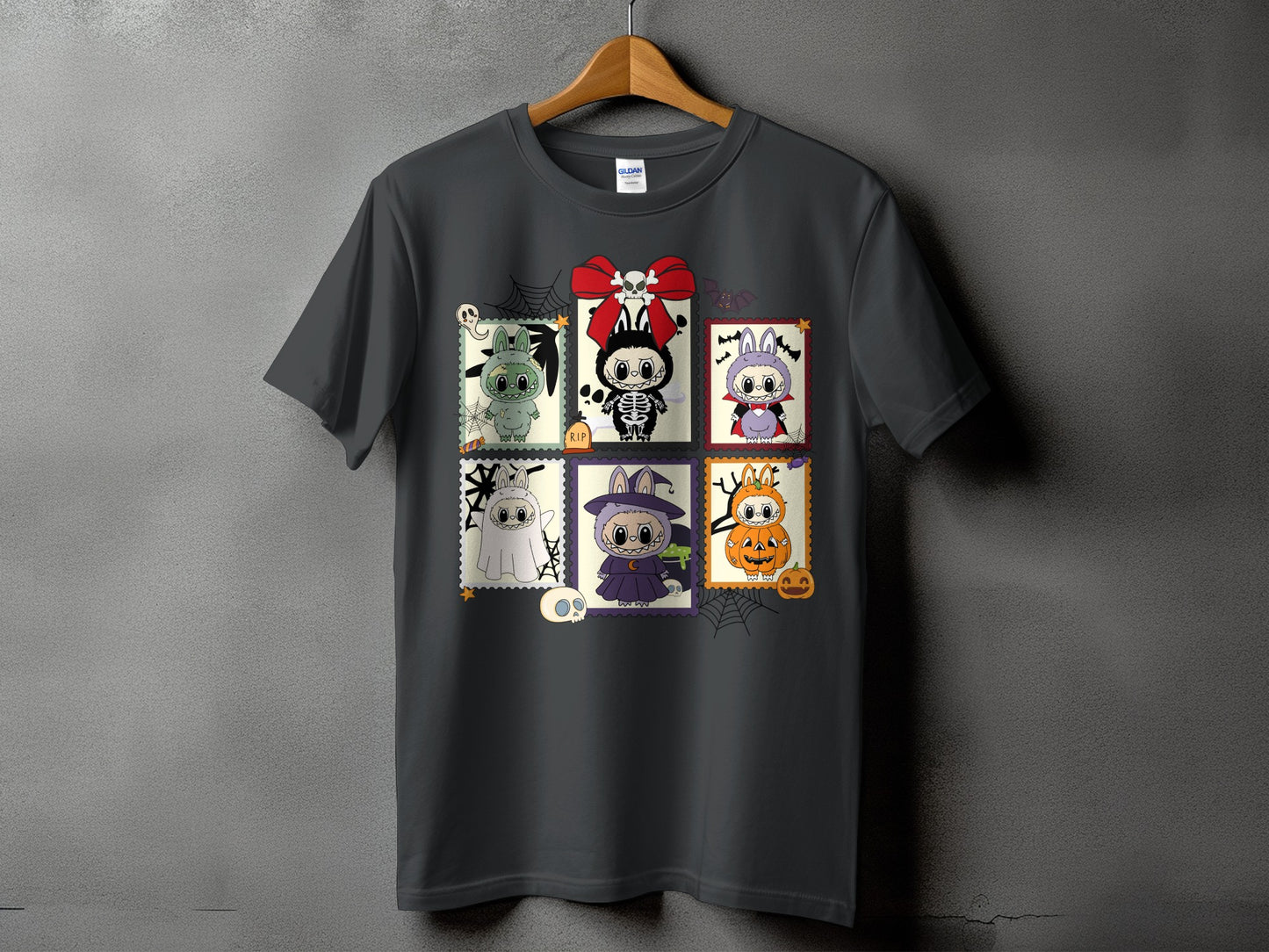 Dark grey t-shirt featuring a Halloween-themed stamp collage with cartoon monsters.