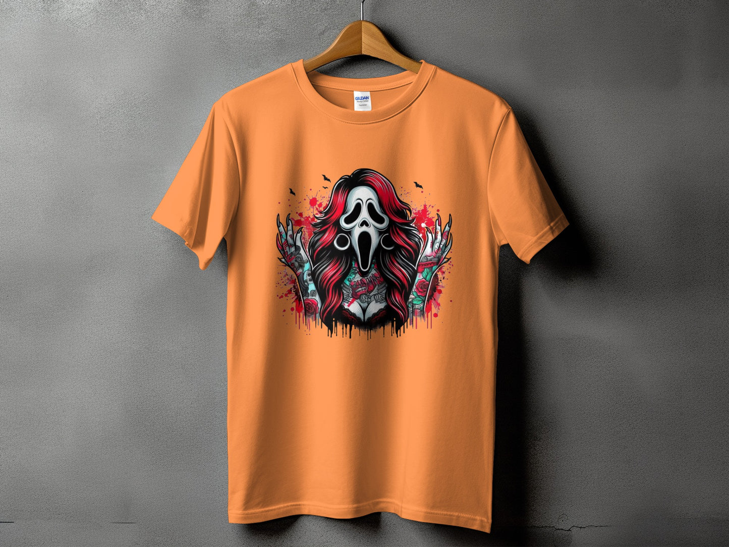 Orange t-shirt with a graphic of a screaming ghost mask and tattooed arms.
