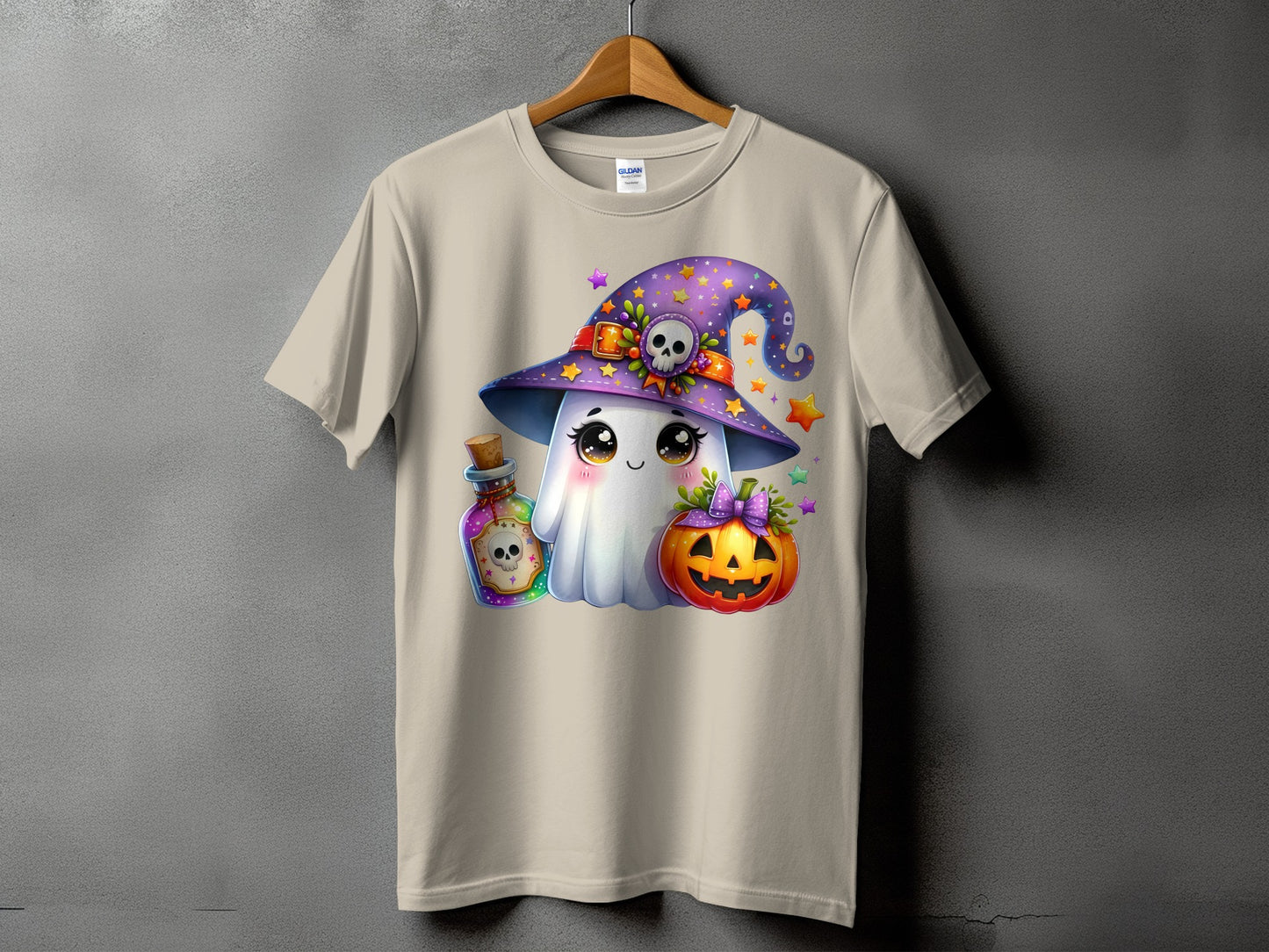 Cartoon ghost in witch hat with potion and pumpkin, on a tan t-shirt.