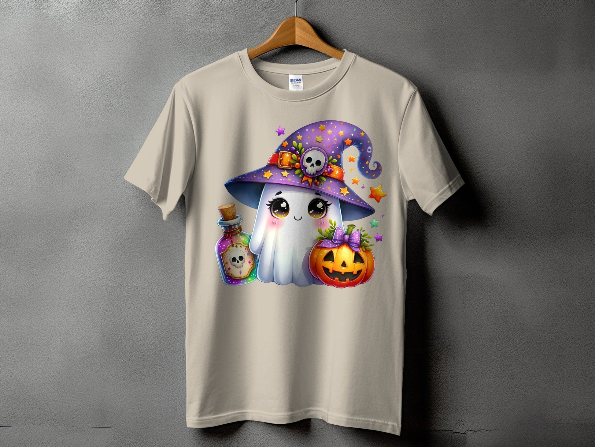 Cartoon ghost in witch hat with potion and pumpkin, on a tan t-shirt.