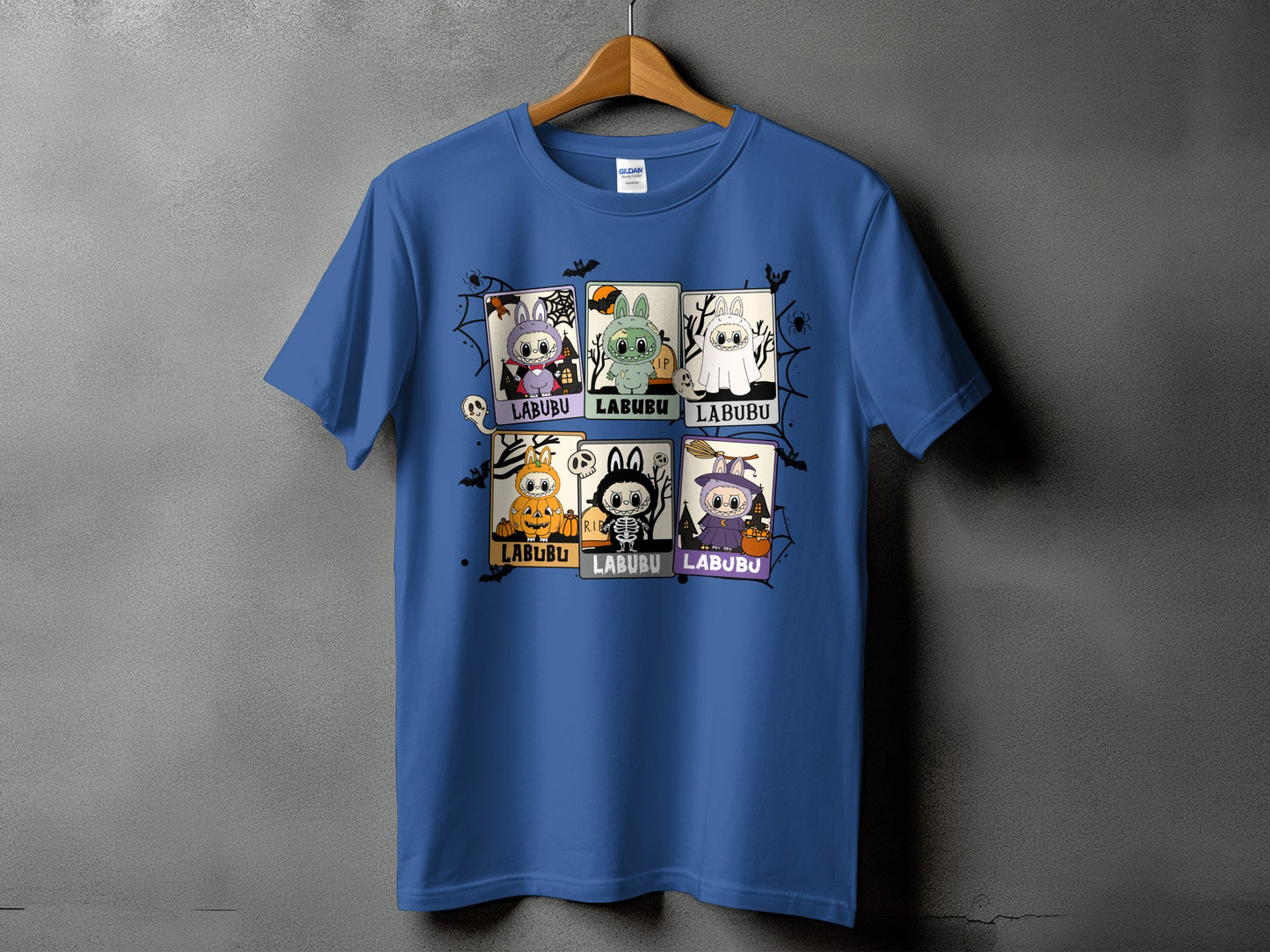 Blue t-shirt with six Halloween-themed Labubu character panels and spider web graphics.