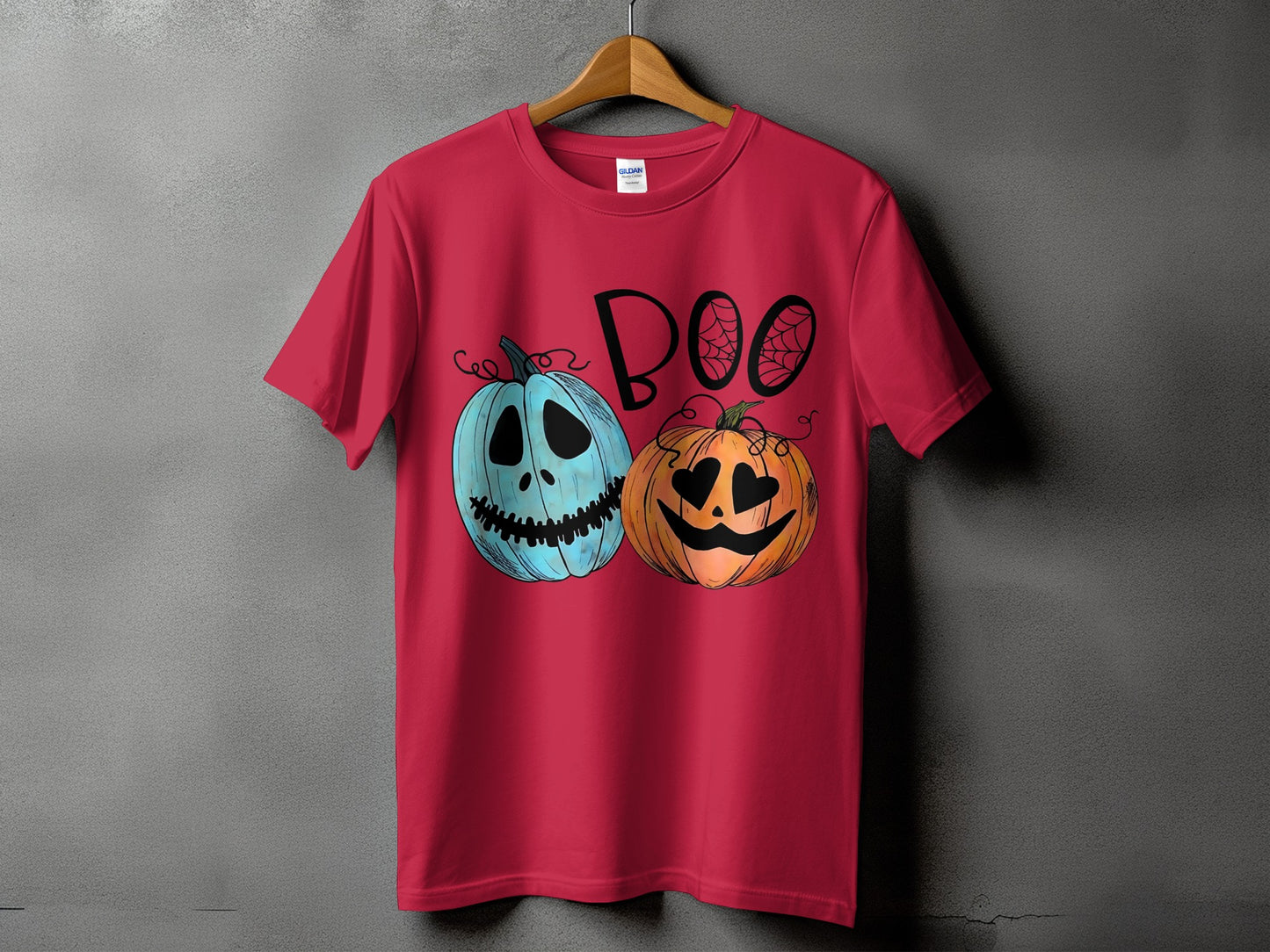 Red t-shirt with cartoon pumpkins and the word "BOO" in black lettering.