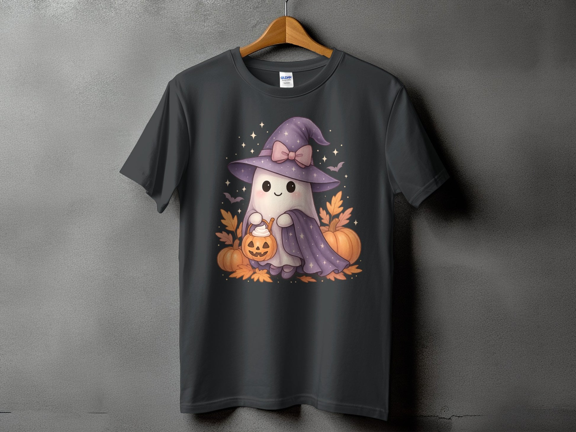 Ghost wearing witch hat holds pumpkin bucket with pumpkins and autumn leaves.