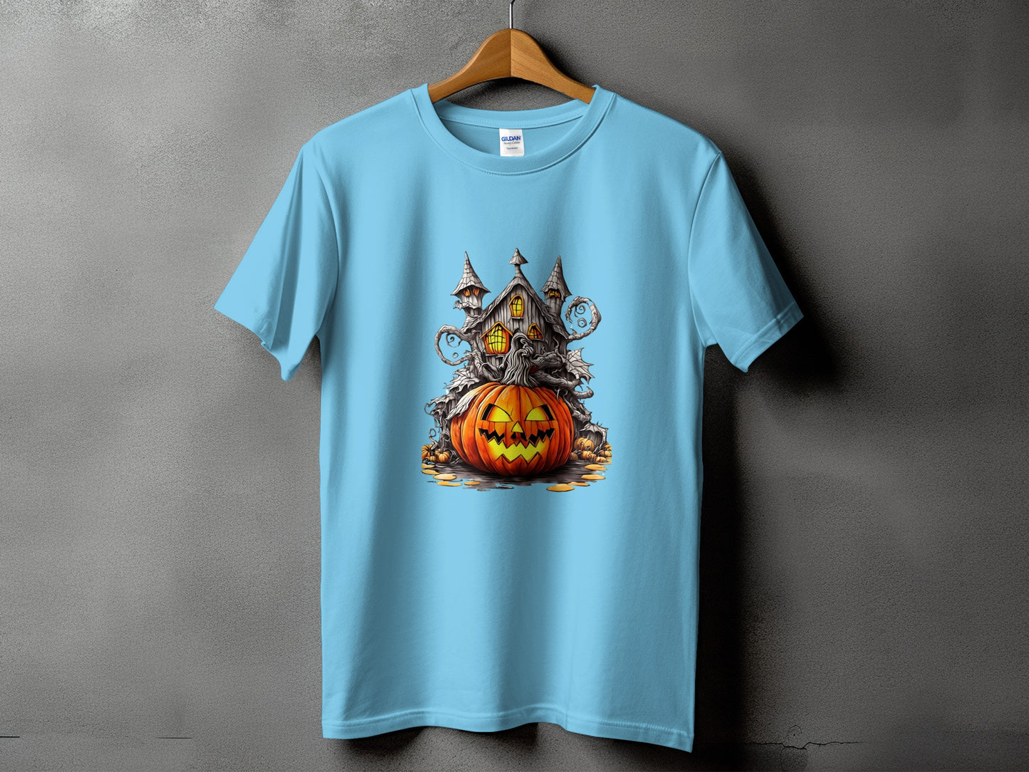 Light blue t-shirt with a spooky Halloween graphic of a haunted house and jack-o'-lantern.