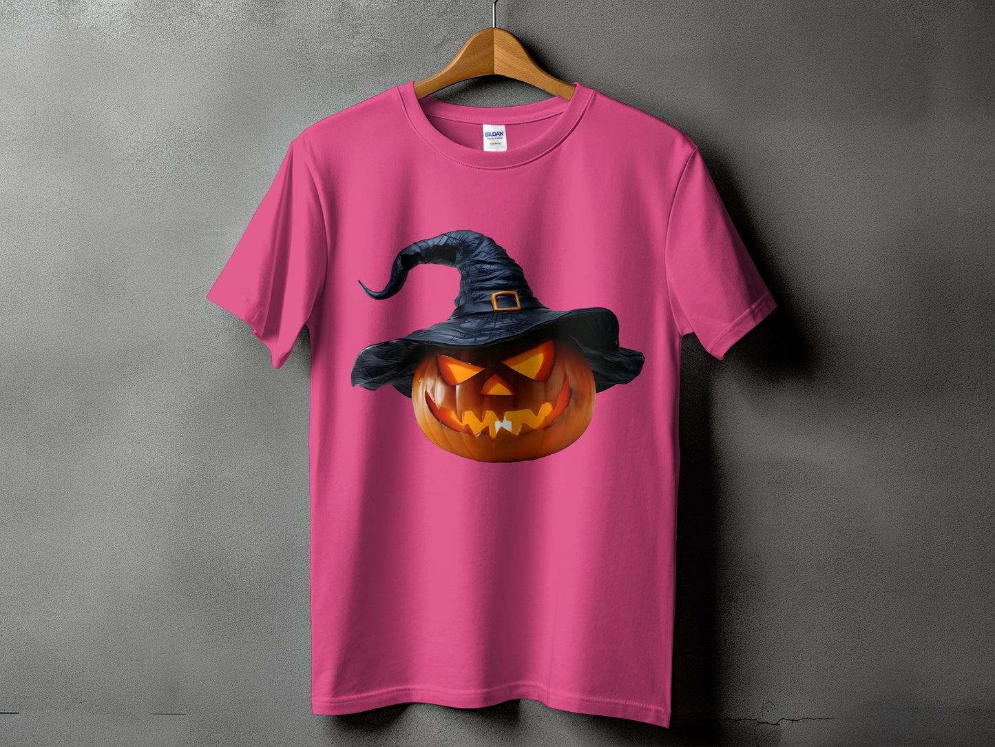 Pink t-shirt with a spooky jack-o'-lantern wearing a witch hat.