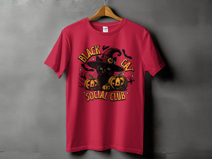 Red t-shirt with black cat, pumpkins, witch hat, bats, and text.