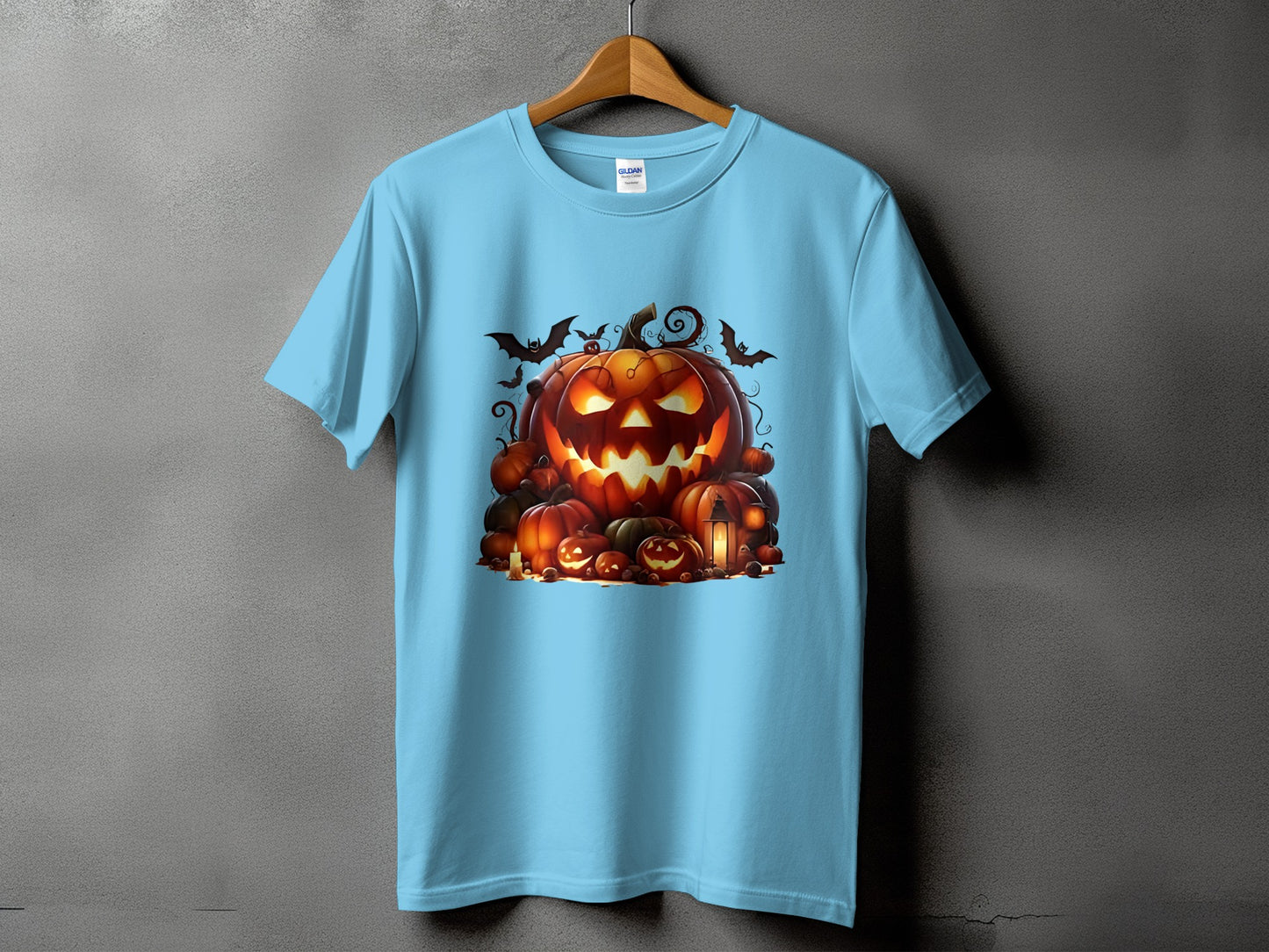 Light blue t-shirt with a Halloween graphic featuring carved pumpkins and bats.