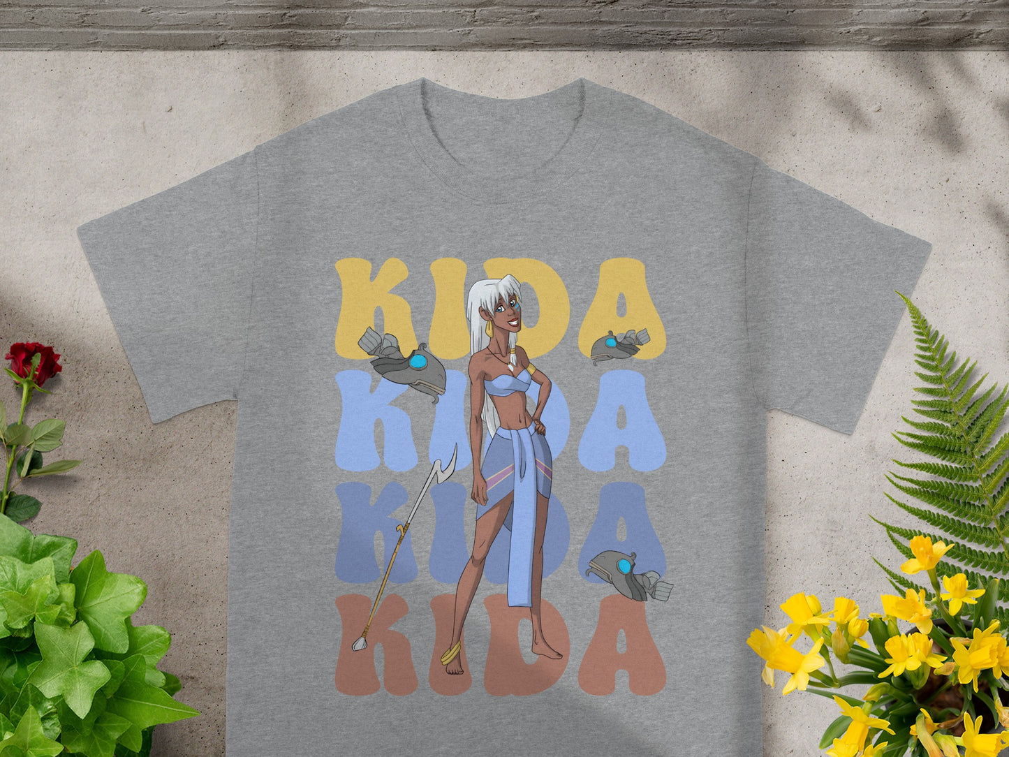 Kida in blue and gold dress with Kida text on grey t-shirt.